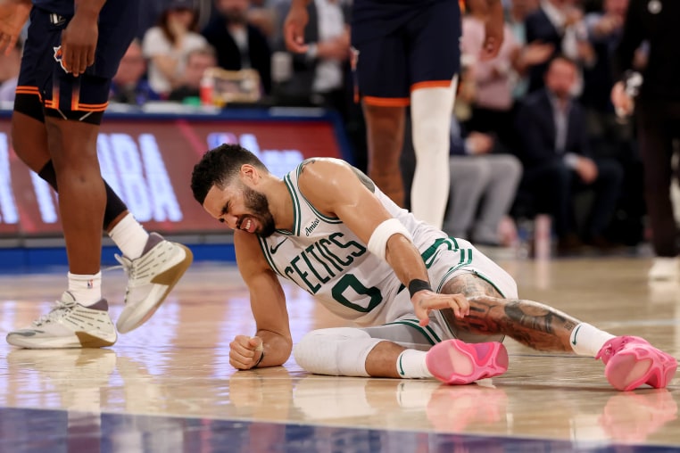 Jayson Tatum winces in pain on the ground after being injured against the New York Knicks