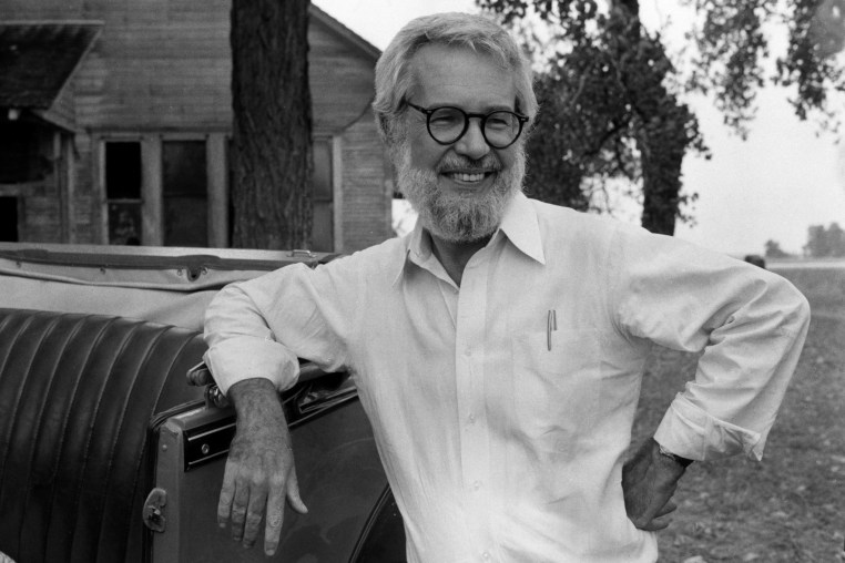 Robert Benton, leaning against a vintage car